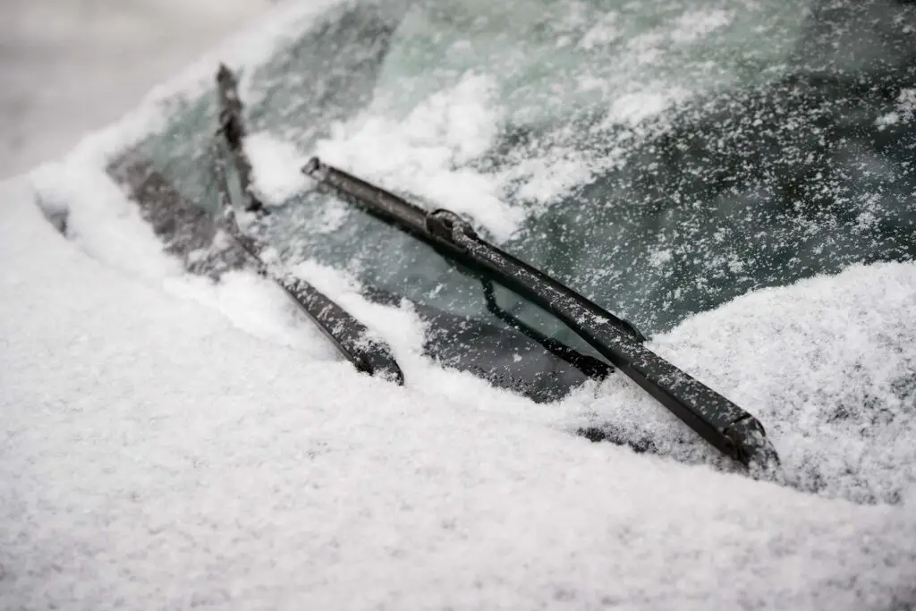 Car wiper blades with snow on them 
