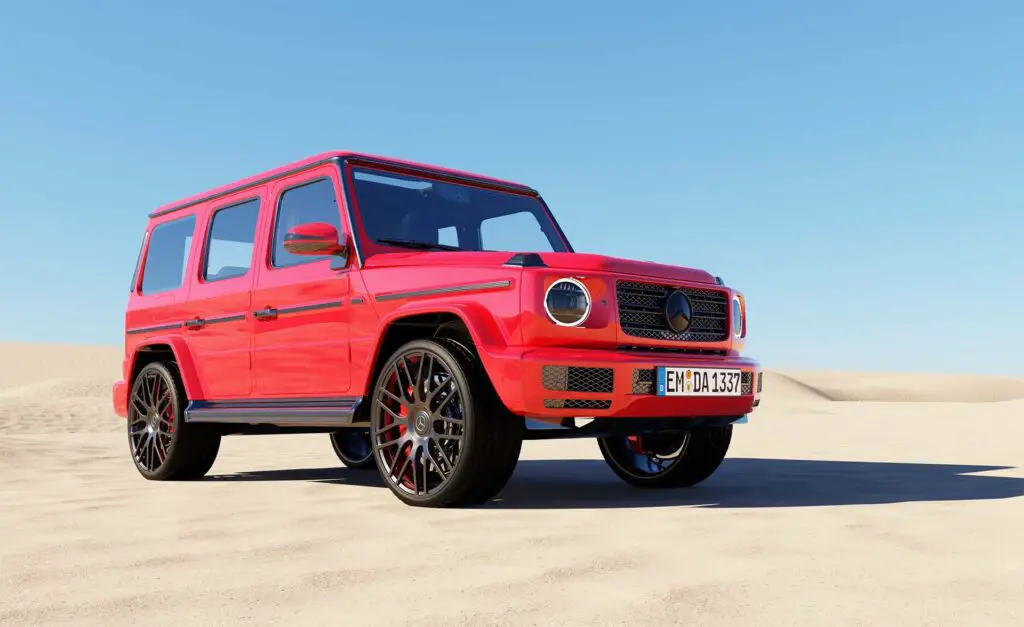 A red Mercedes G-Wagon on sand