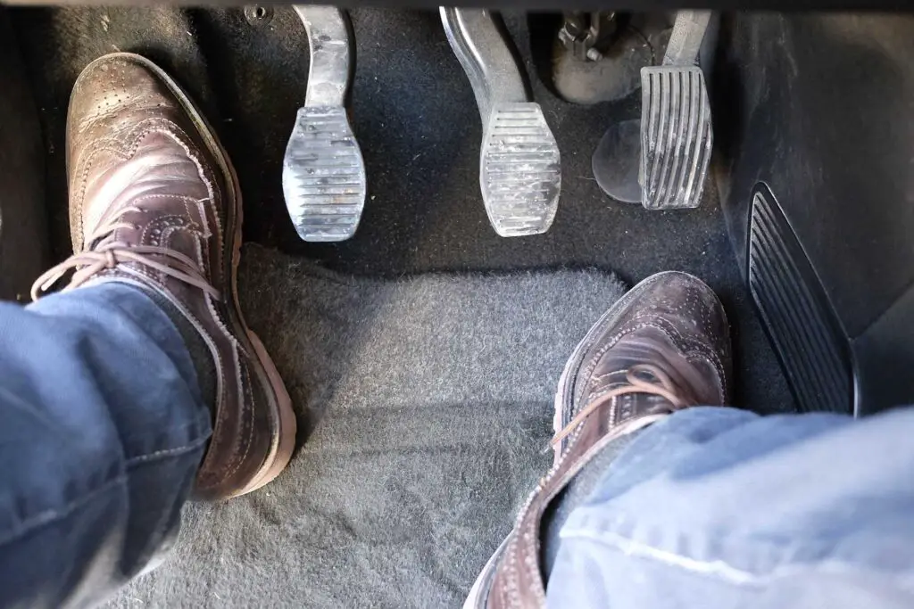Person's legs on the car pedals