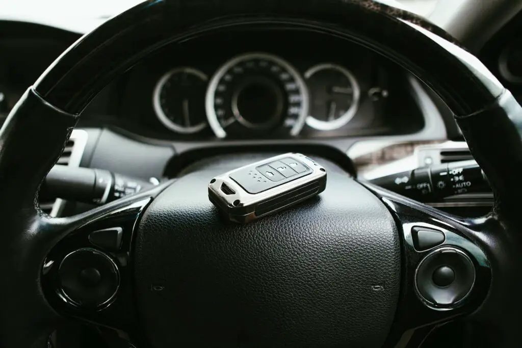 Car steering wheel with keyless remote in the car, Automotive concept.