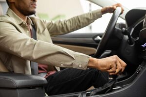 African american man driving his car shifting gears. High quality photo