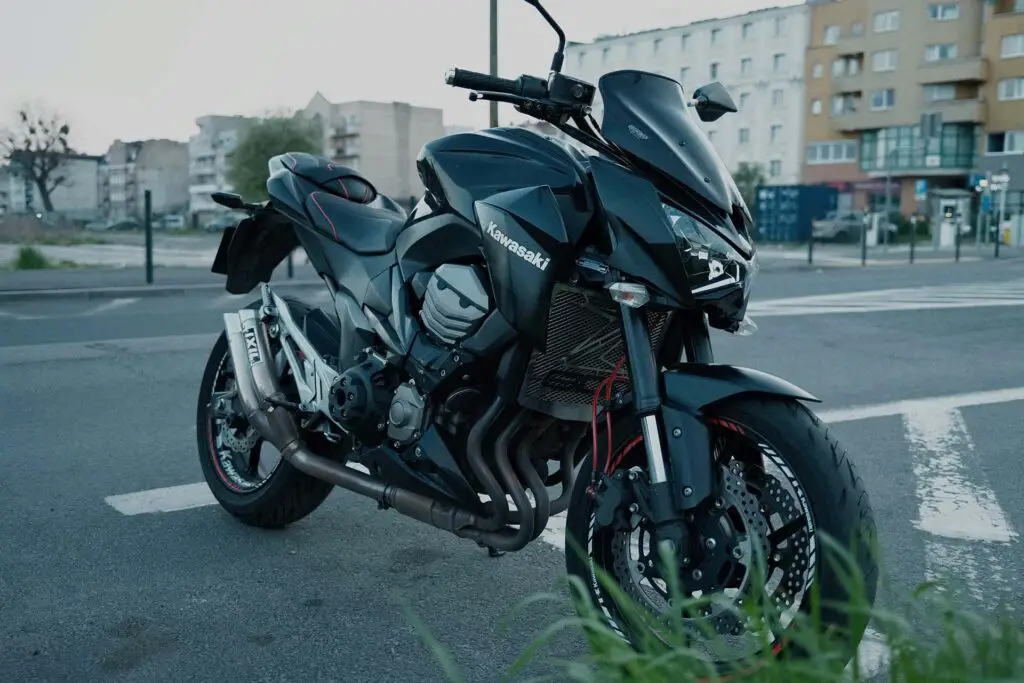 A black Kawasaki motorcycle parked on the side road