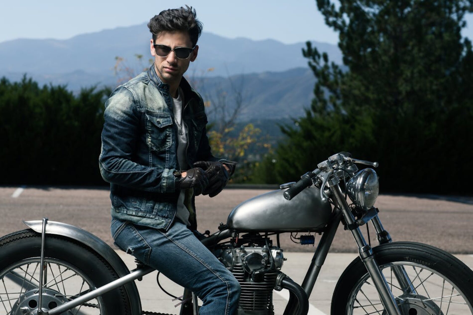 A man in sunglasses sitting on a motorcycle