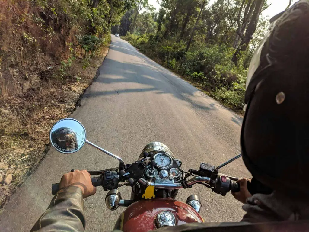A man with a helmet riding a motorcycle