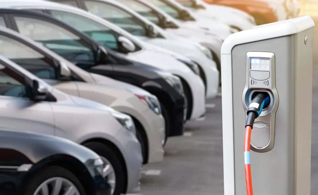 Close-up of a electric charging station on the background of cars