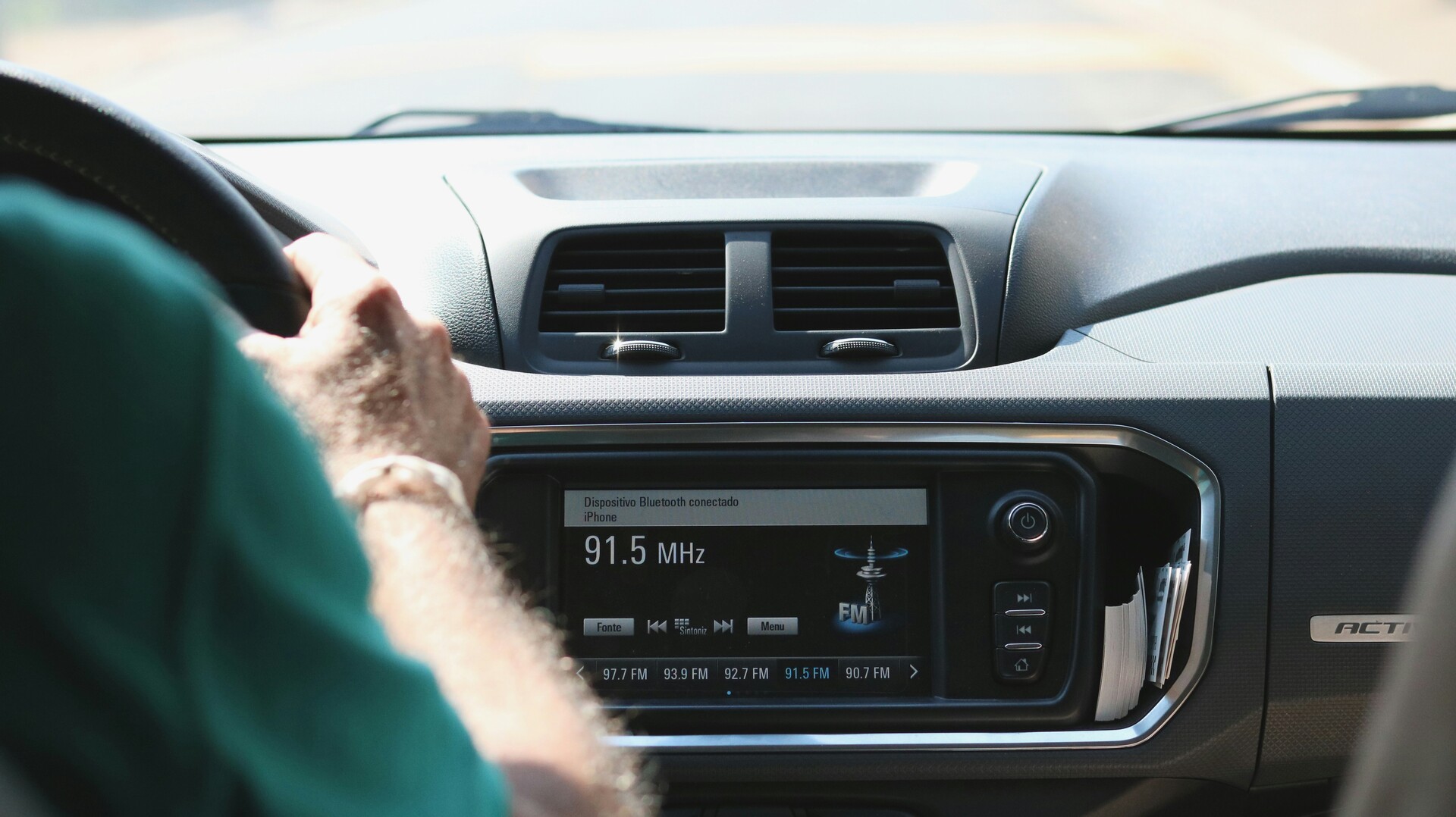 Person driving with the radio on