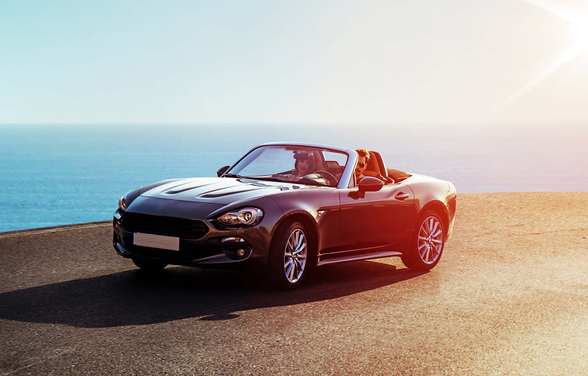 Young, elegant couple riding a luxurious convertible