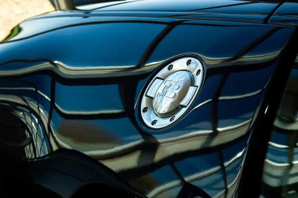 A close-up of the Bugatti logo on a black car