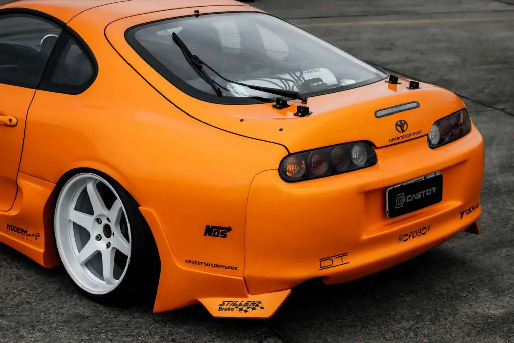 The back of an orange Toyota Supra