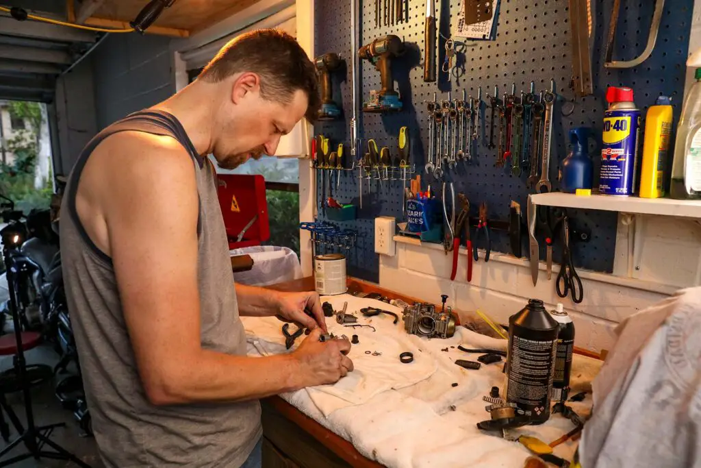 A man cleaning car parts