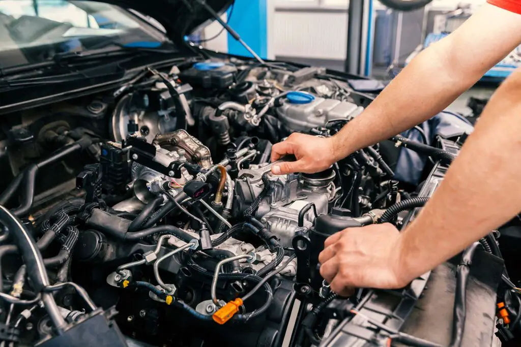 mechanic working on engine repairs, close up