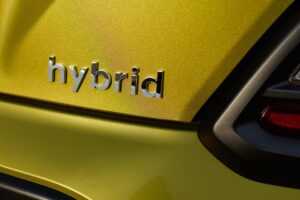 Chromed hybrid car logo on background