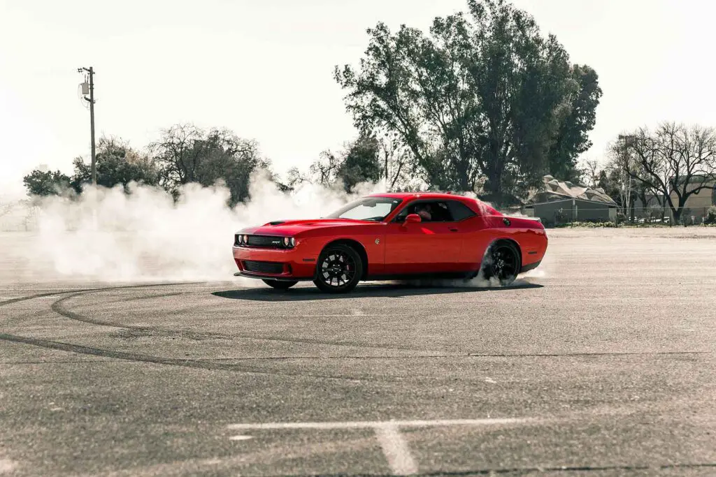 Red Coupe drifting on asphalt