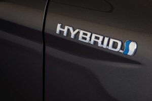 2024_Toyota Hybrid badge emblem on modern car body, Toyota Hybrid Technology and Innovation logo