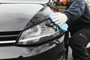 A man cleaning a waxed car