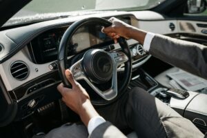 A person in a suit driving a car