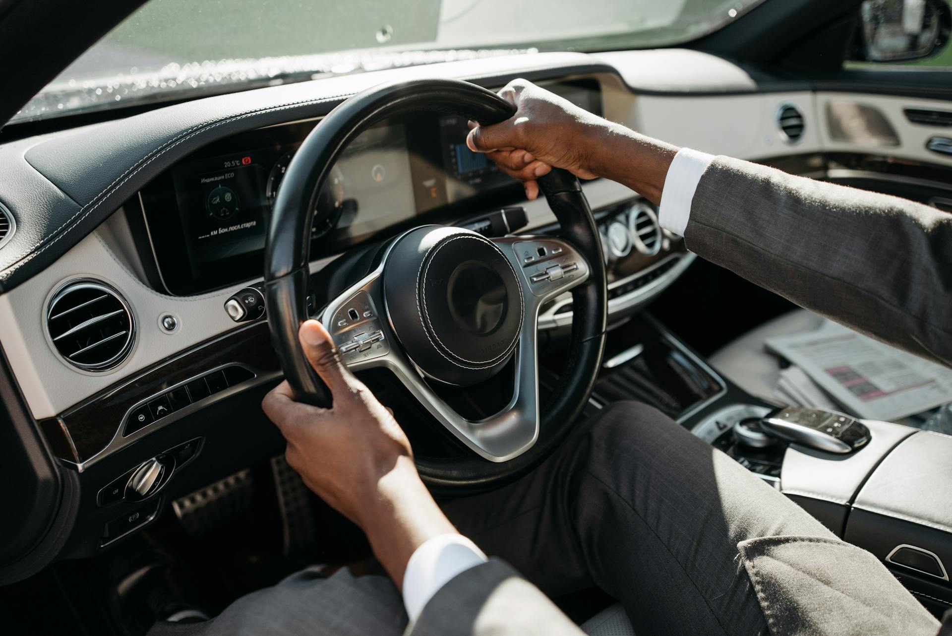 A person in a suit driving a car