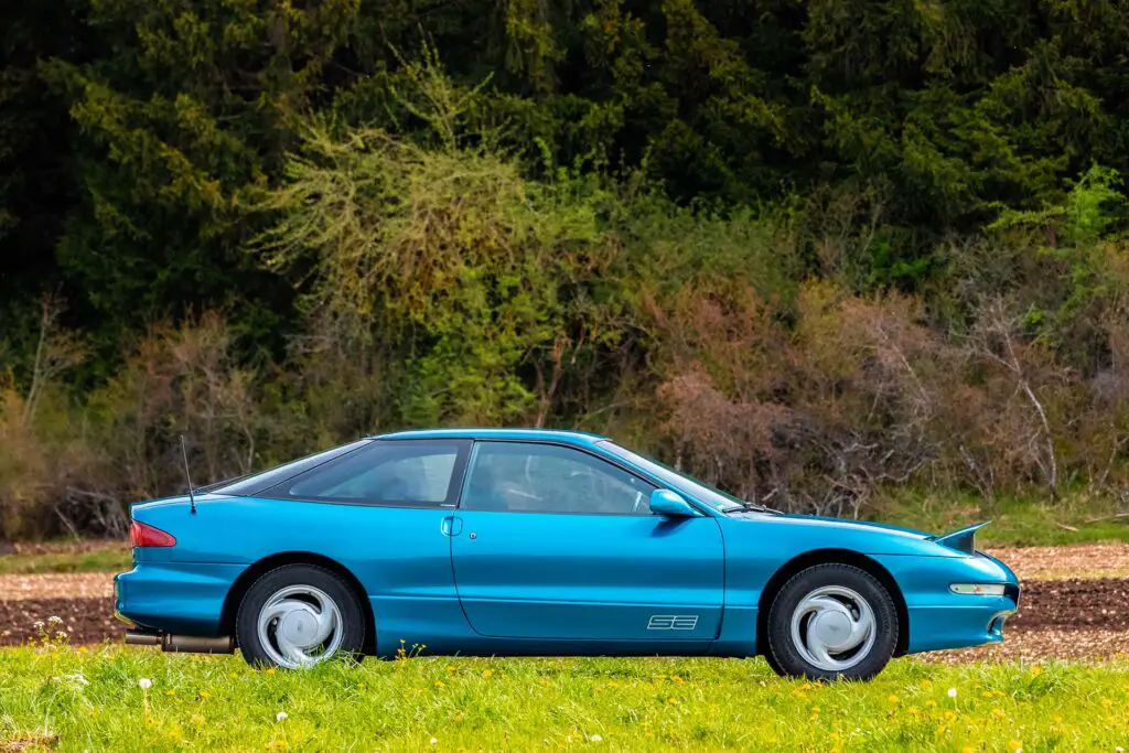 A blue Ford Probe on the road