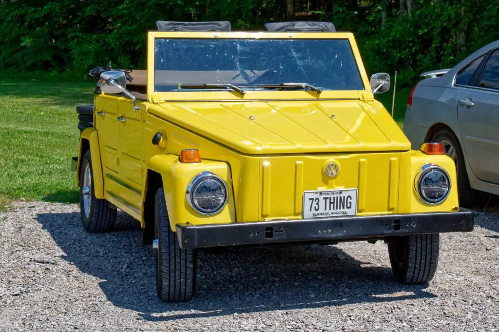 Bright yellow convertible 1973 Volkswagen car called the Thing restored with some upgrades parked outdoors on a sunny day in summertime closeup view
