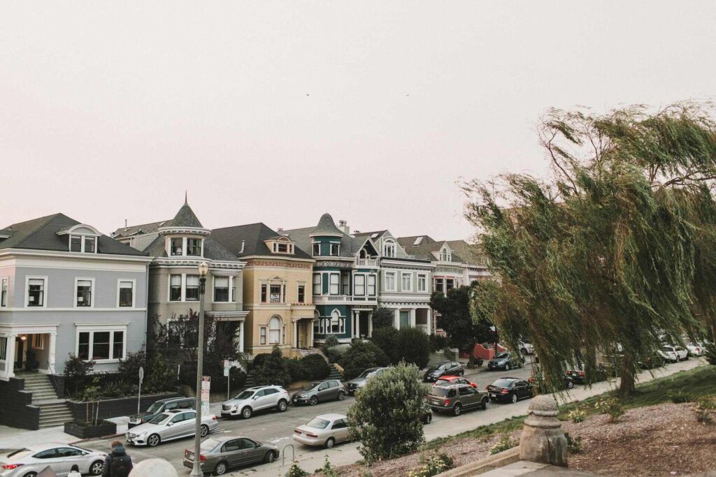 A neighborhood in San Francisco with cars parked on the street